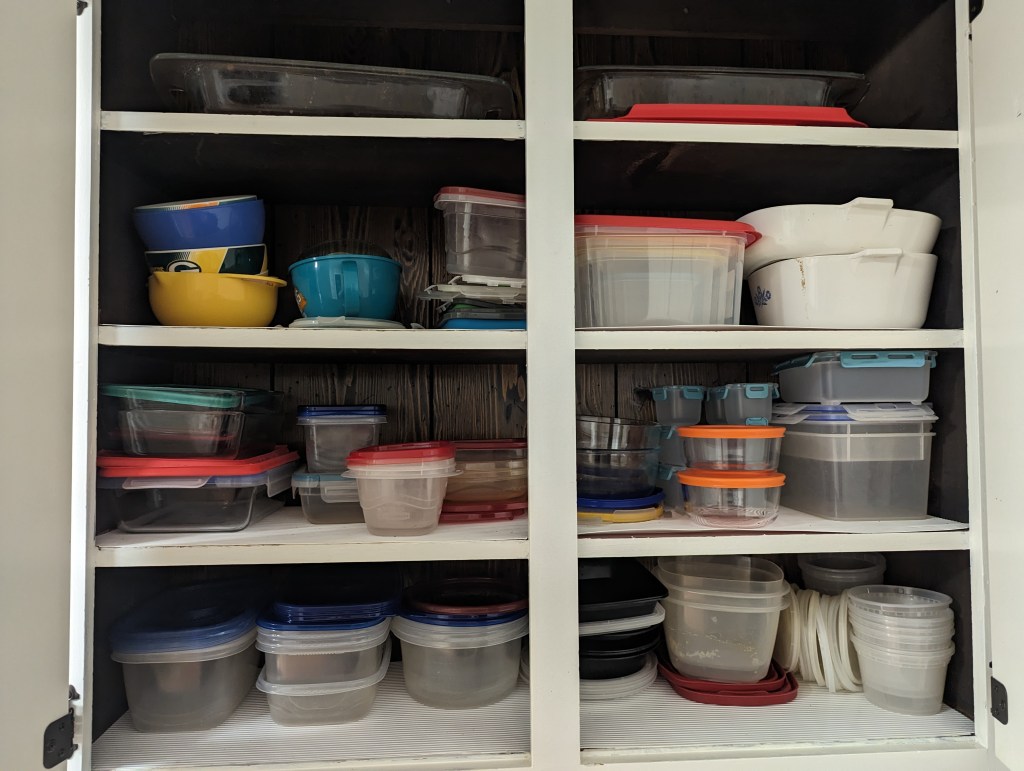 My plastic container cupboard, which also contains Pyrex glassware and Corningware.
