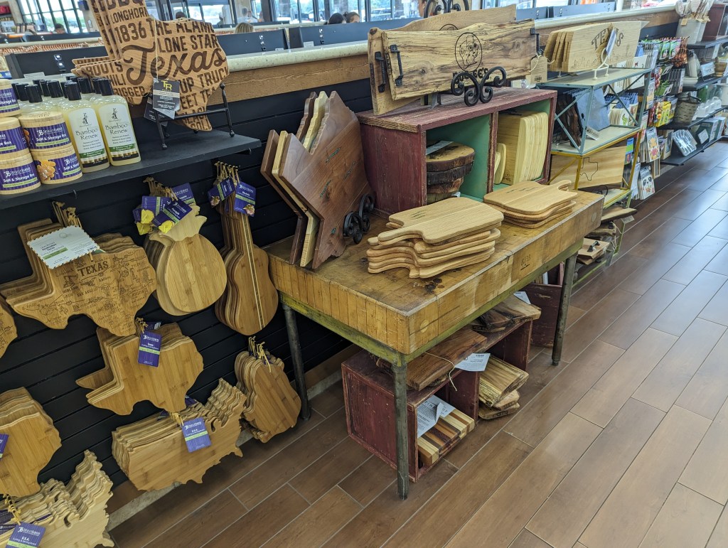The "spanking department" at Buc-ee's in Terrell, TX: a display of wooden cutting boards (that look like paddles) and other wooden display pieces.