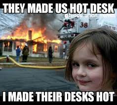 The "little girl with the burning house in the background" meme with the text: "They made us hot desk; I made their desks hot."