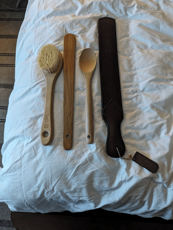 The bath brush, the evil stick paddle, the wooden spoon, and the GASP strap.